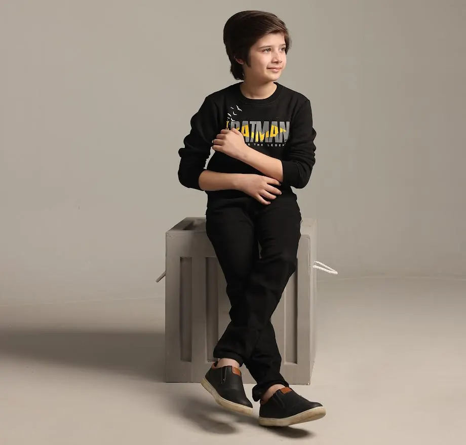 Child sitting on a stool in a stylish pose
